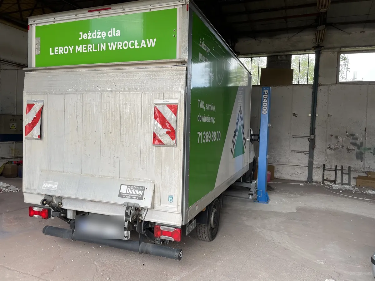 Wysokie auto dostawcze z kontenerem w hali warsztatu